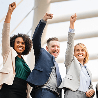 Group of people holding their hands up and feeling accomplished.